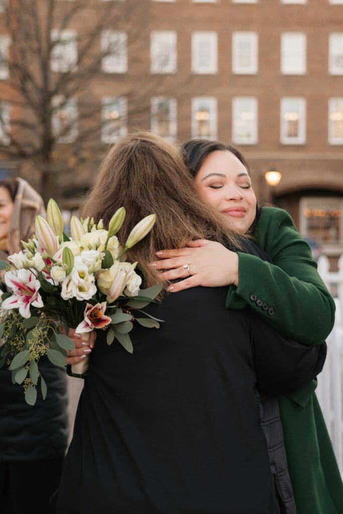 Bride warmly hugs a family member after small and personal elopement vows in Northern VA