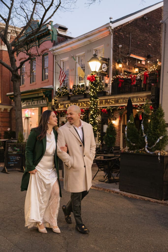 couple strolls down King Street in Old Town as the sun sets after their evening elopement ceremony