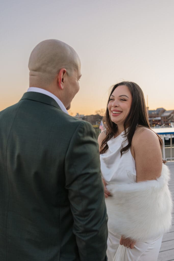 Bride smiles at her groom during intimate bridal portraits overlooking the Potomac at sunset