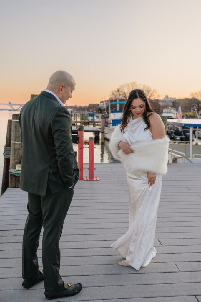 bride and groom smile at each other during waterfront wedding portraits in Old Town Alexandria