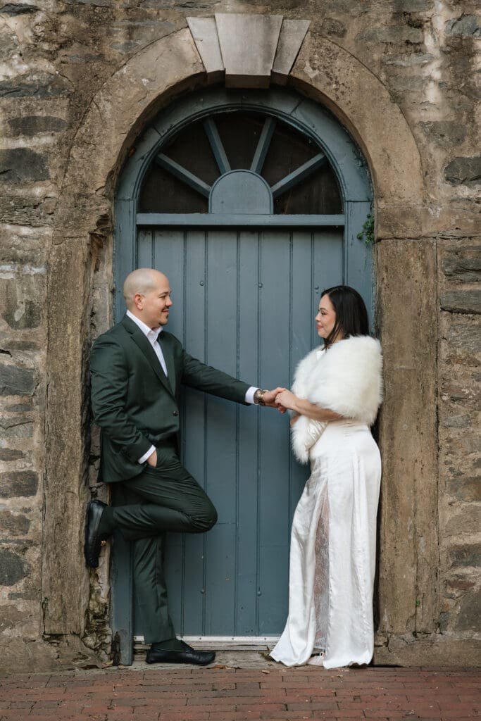 bride and groom pose during bridal portraits at Carlyle House in Old Town Alexandria
