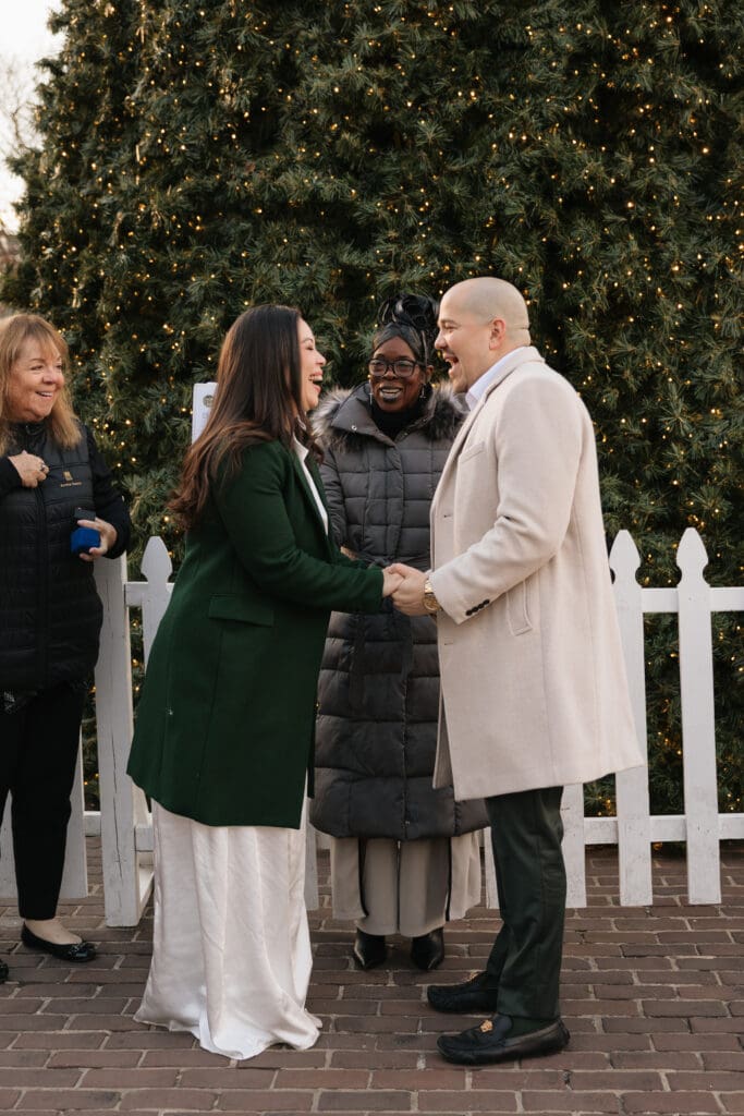 couple shares a laugh during their elopement ceremony surrounded by family
