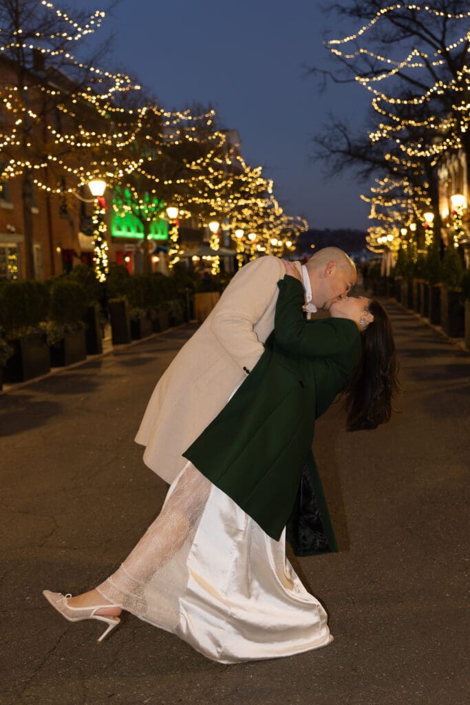 couple dips for a romantic kiss during blue hour after elopement in Old Town Alexandria