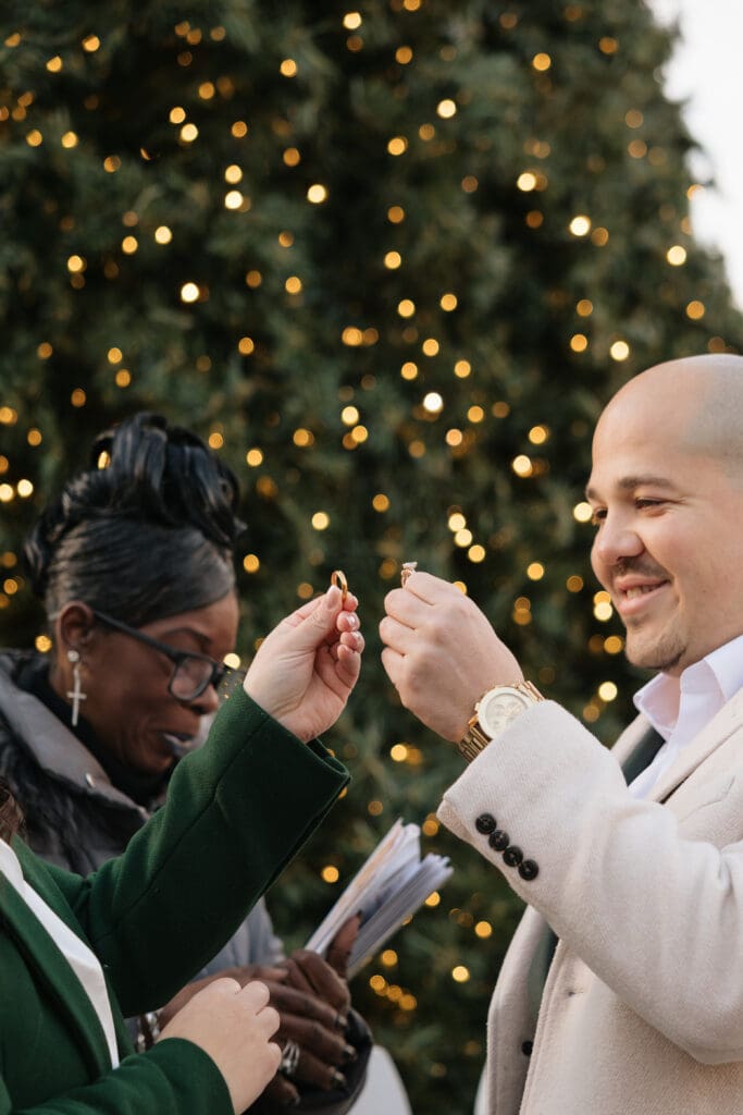 A couple raises their wedding bands for a blessing during their heartfelt elopement ceremony