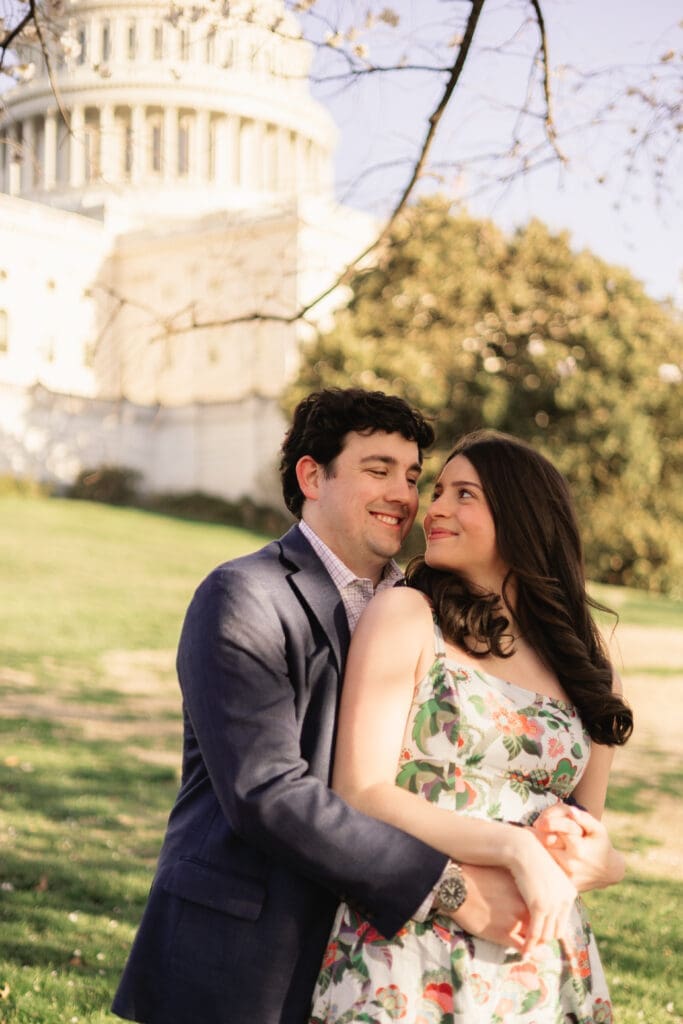 Couple hugs during a golden hour engagement photoshoot in Washington DC
