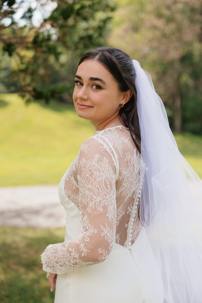 bride shows off her detailed dress before Northern VA wedding ceremony