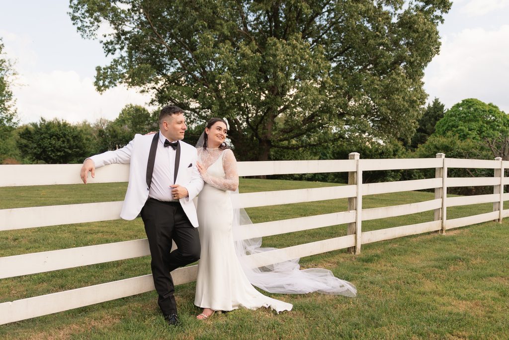 newlywed couple poses for a wedding portrait after their backyard wedding ceremony