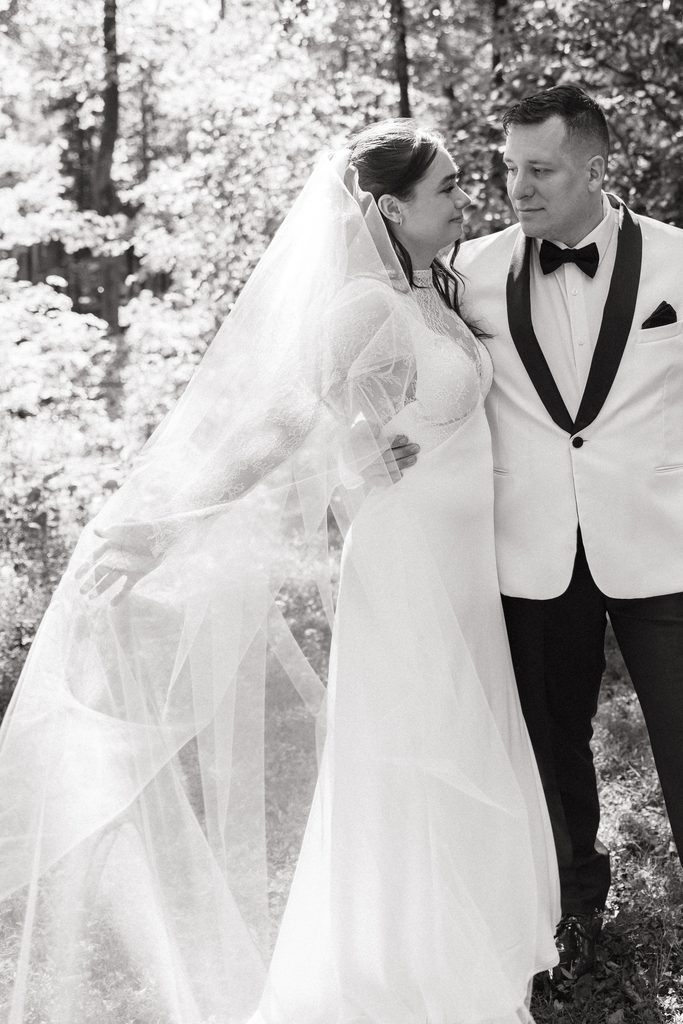 black and white wedding portrait showcasing the bride's cathedral veil after Northern VA wedding ceremony