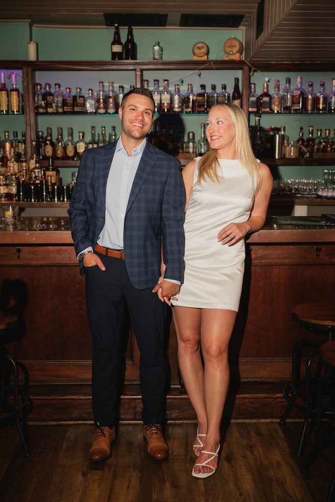 newly engaged couples smile for engagement photos in Old Town Alexandria