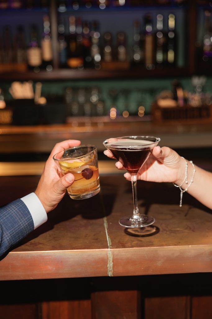 newly engaged couples cheers their drinks during engagement session photos